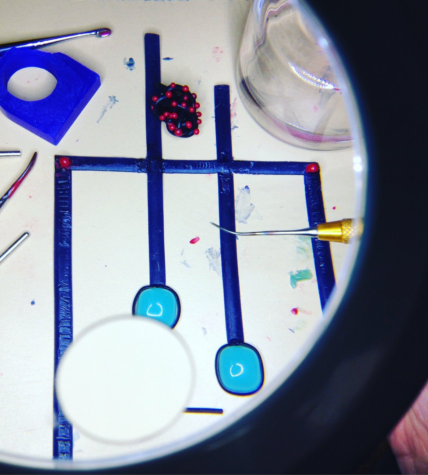 Jewelry designer inspecting handcrafted wax models during the jewelry design process by Carlotta di Montefalco